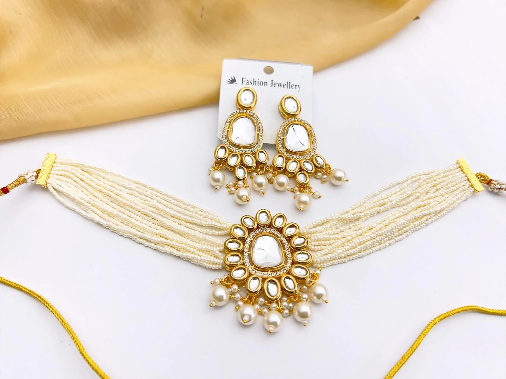 Premium White Kundan Choker Necklace Set with Drop Earrings Shop luxury South Asian fashion online in the UK. This premium artificial Kundan necklace set features adjustable sizing, high-shine mirror stones, and elegant multi-strand pearls, delivering boutique luxury directly to your doorstep.