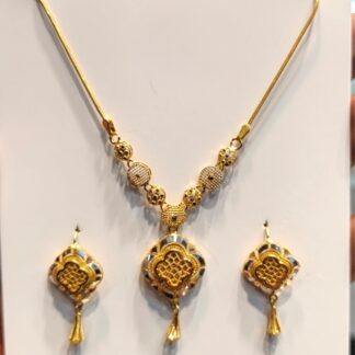 Shop a 22K gold quatrefoil medallion necklace and matching drop earrings with textured geometric detailing. Traditional-inspired jewelry for weddings and special occasions.
