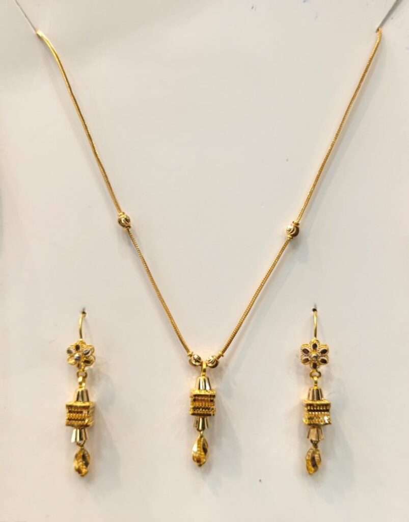 Shop a delicate Chicago Floral Drop 22K Gold Jewelry Set with a slim yellow-gold necklace and matching floral drop earrings for weddings and special occasions.