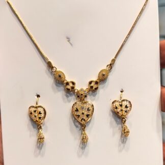 Modern Chicago Heart 22K Gold Jewelry Set Shop the Modern Chicago Heart 22K Gold Jewelry Set featuring a heart-shaped yellow gold necklace and matching drop earrings with decorative contrasting details.