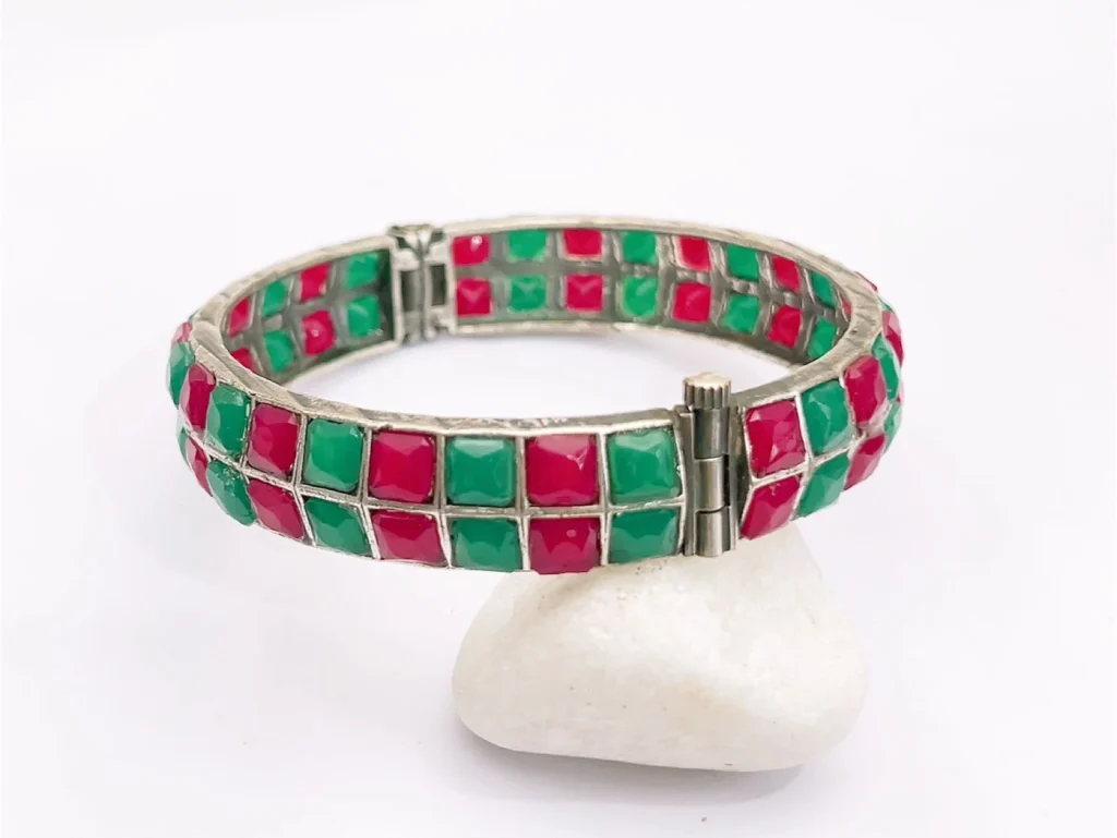 Shop the Vibrant Miami Red & Green Mosaic Statement Bangle featuring colorful geometric stones, a silver-tone finish and hinged clasp design.